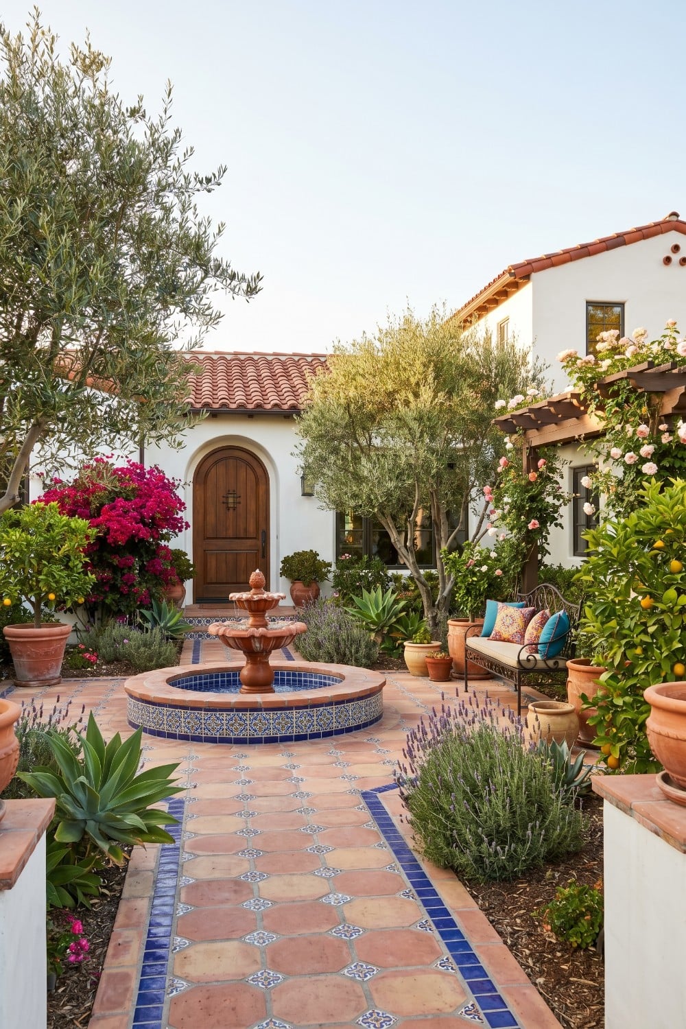Cobalt Blue Tiled Courtyard with Olive Trees