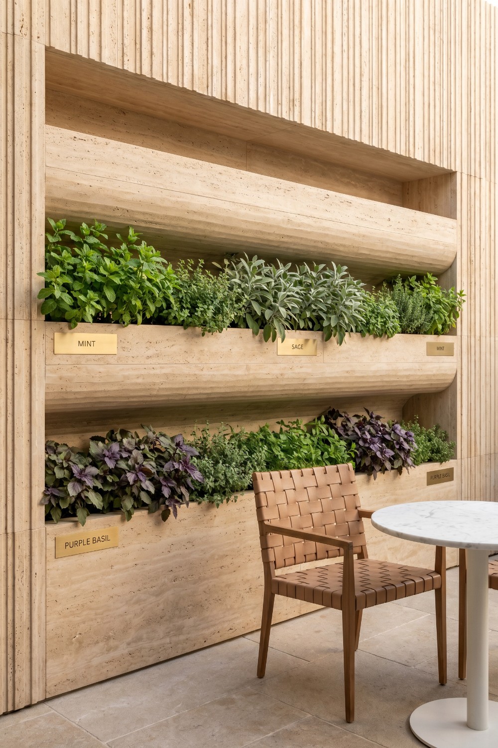 Fluted stone patio herb garden with brass nameplates