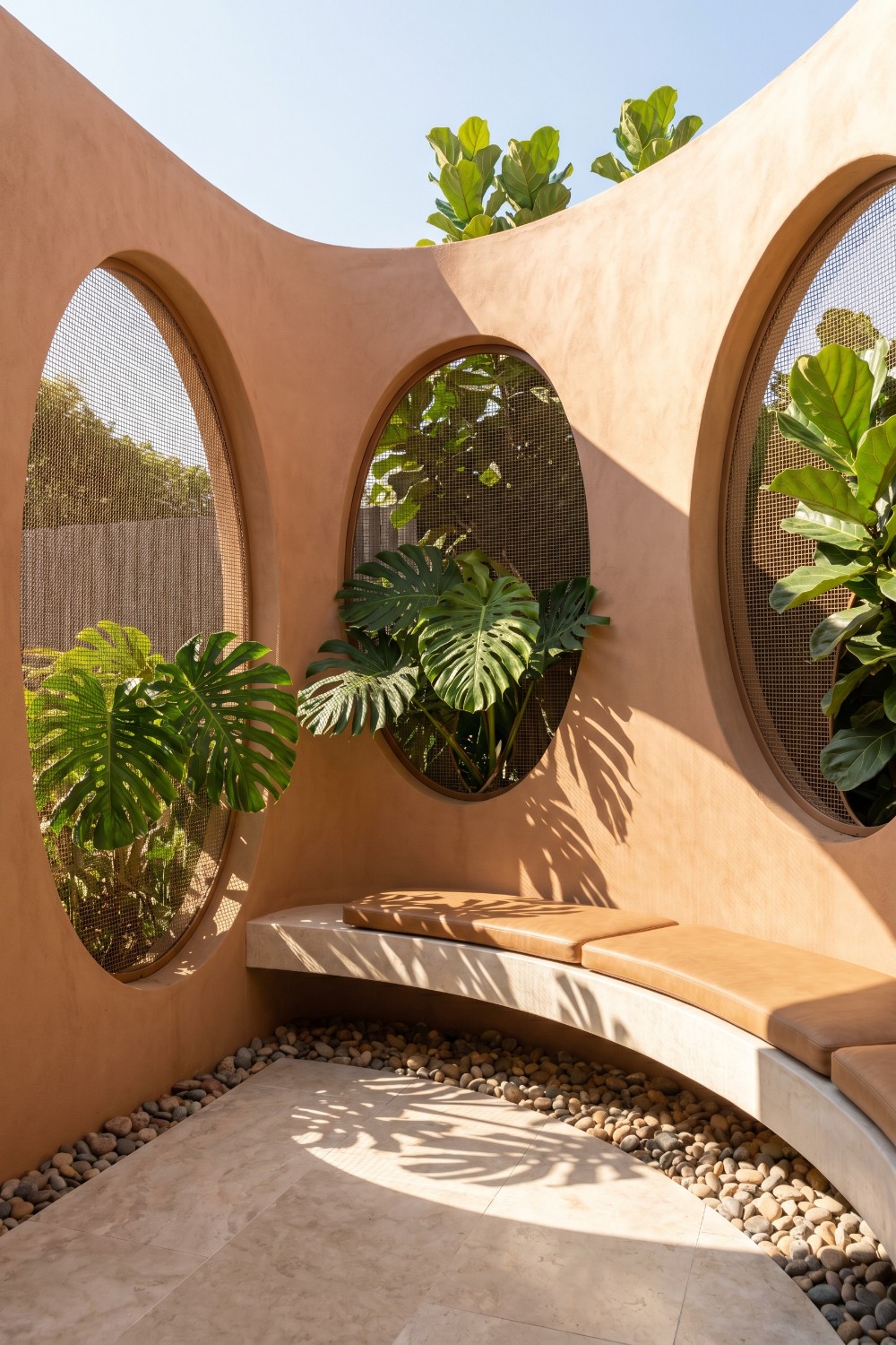 Curved Stucco Patio Privacy and Mesh Oval Cutouts