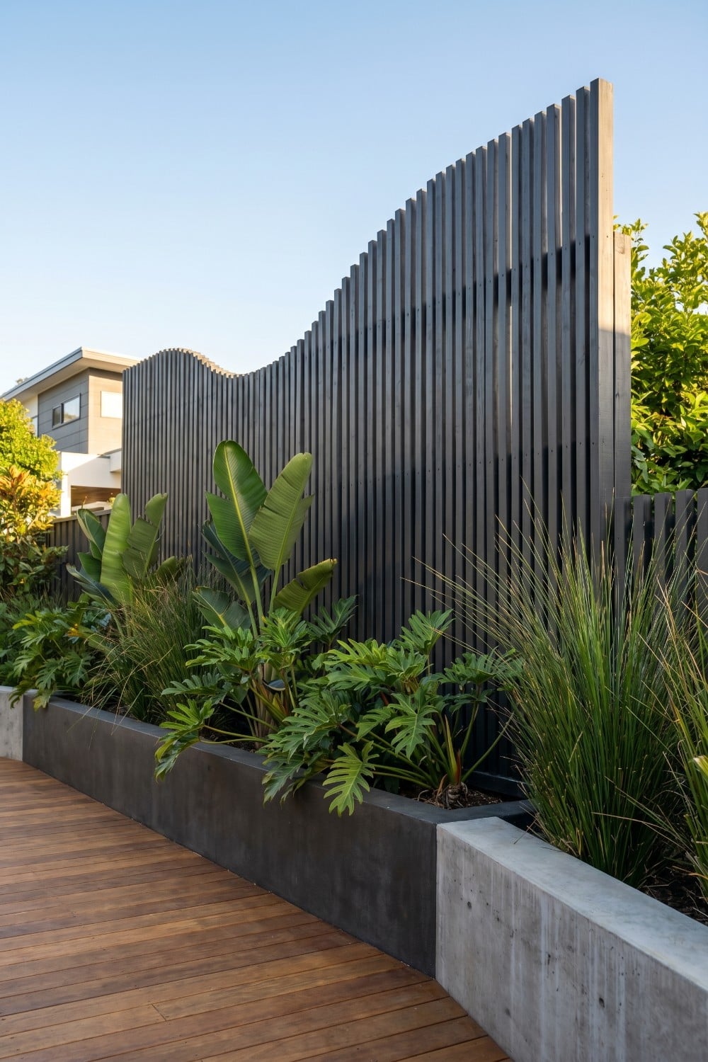 Tall Privacy Fence with Undulating Vertical Slats